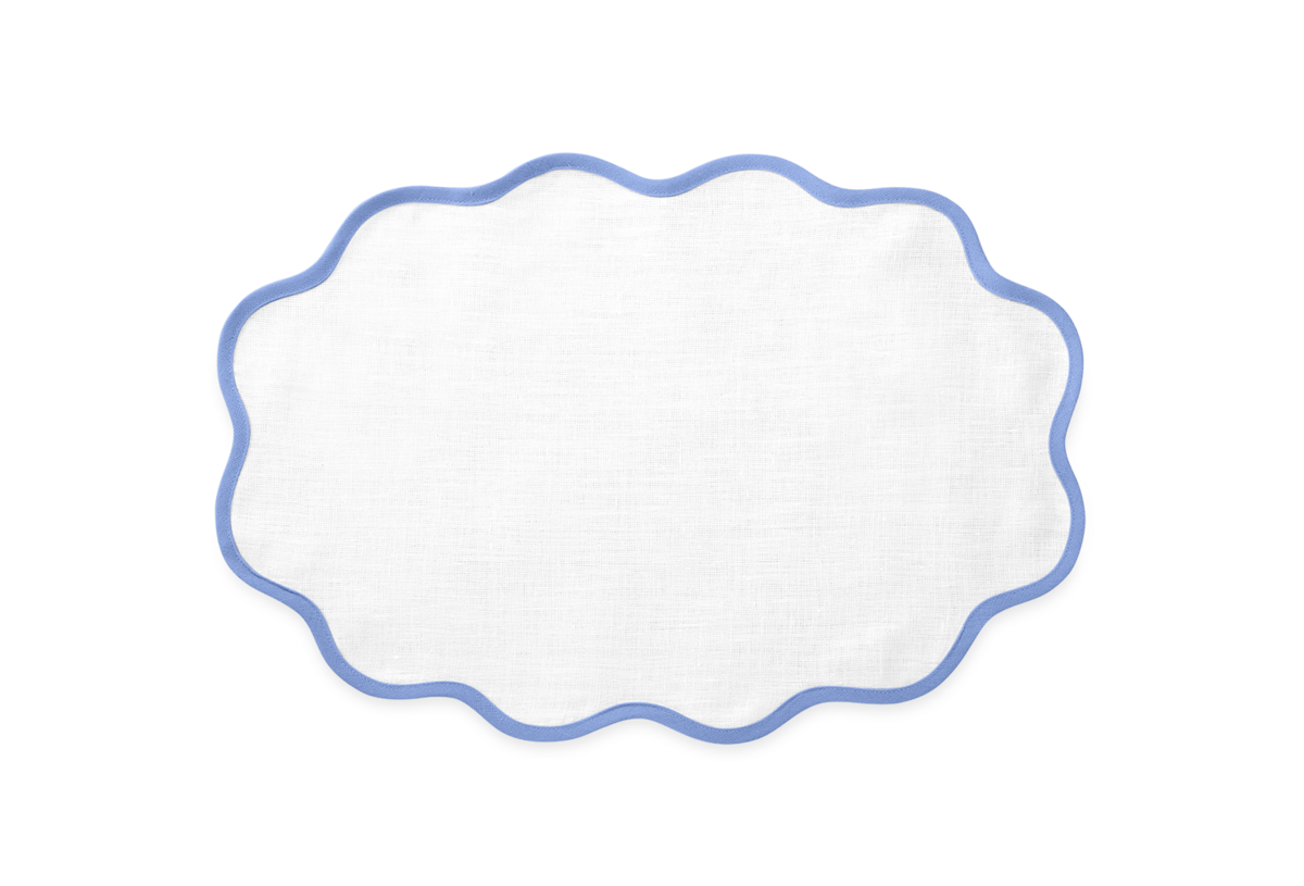 Matouk’s Scallop Edge | Placemat Set features white oval linen placemats with blue-outlined scalloped edges, perfect for elevating your tablescape, shown against a plain light background.