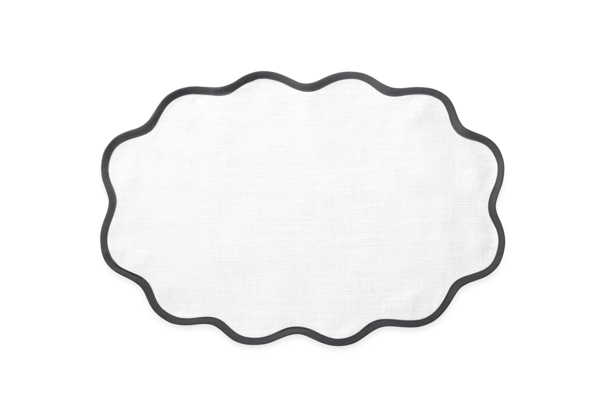 The Scallop Edge | Placemat Set by Matouk features white linen with a scalloped edge and black border, shown on a light gray background—an elegant choice for your tablescape.