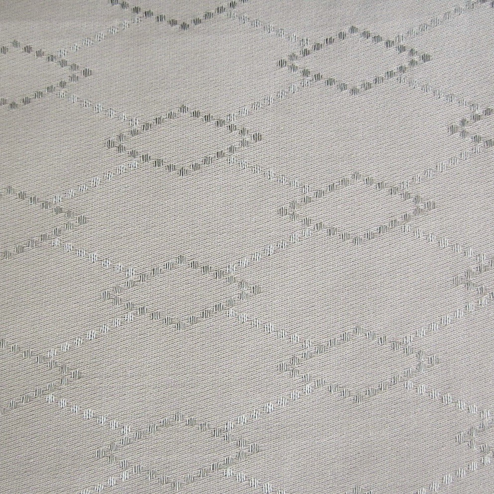 Close-up of Home Treasures Scotland fabric in ivory with woven diamond jacquard pattern.