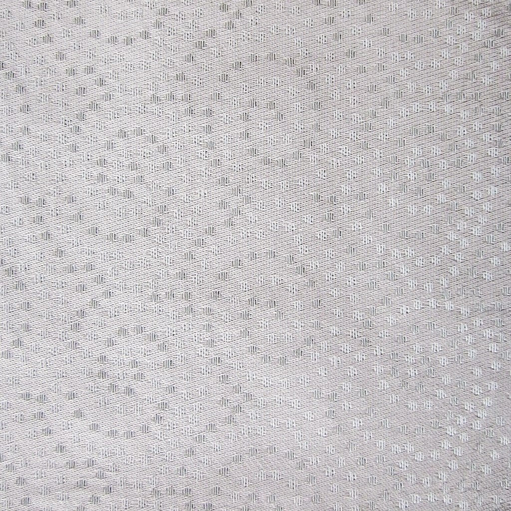 Close-up of Home Treasures Scotland fabric in ivory with tonal woven dot texture.
