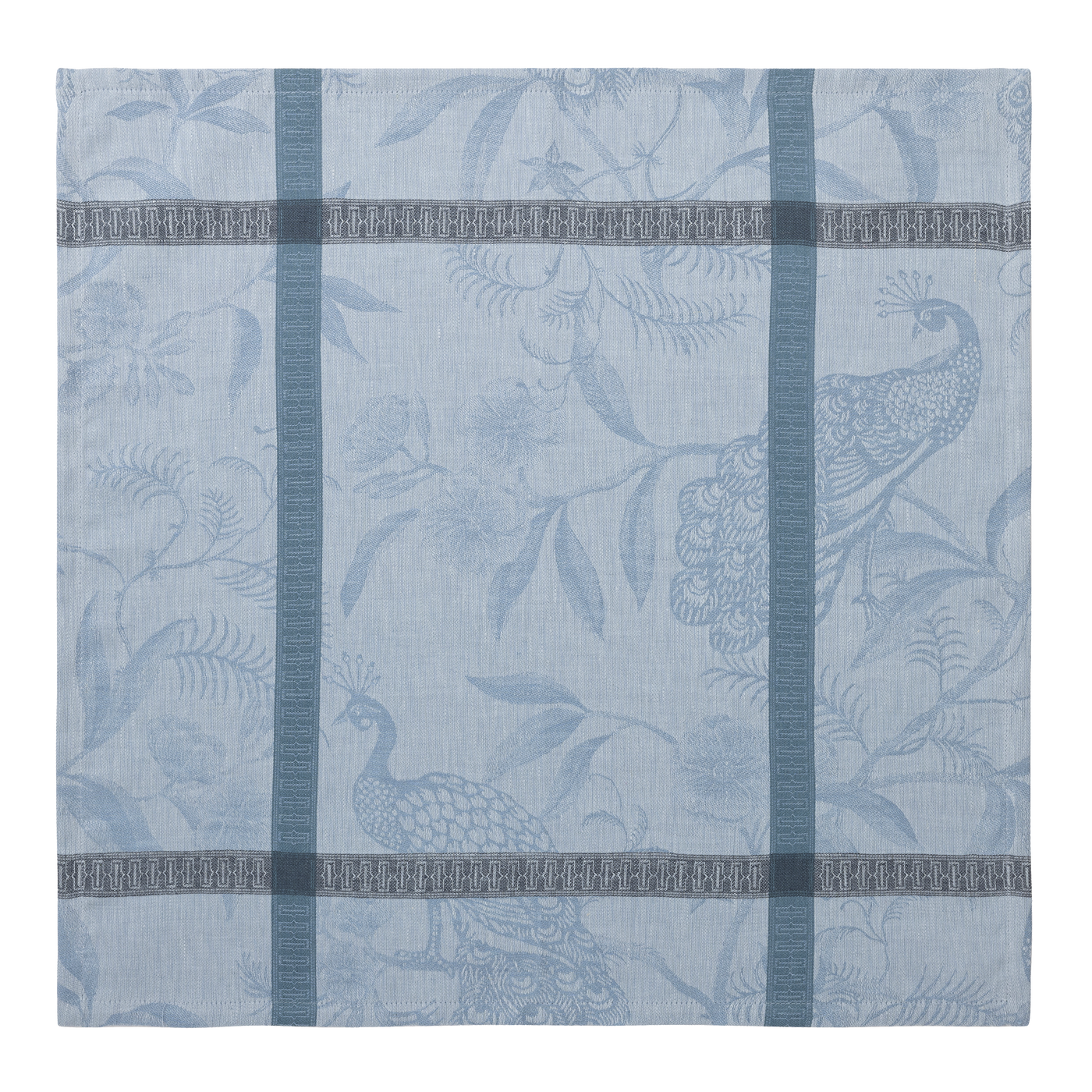 Close-up of dusty blue jacquard napkin with woven peacock and botanical motif.