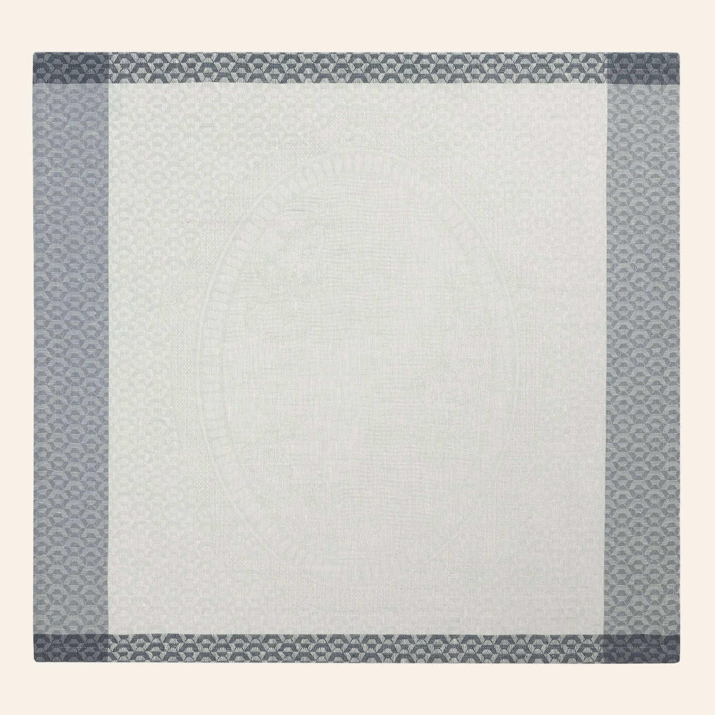 Le Jacquard Français Évasion Céleste napkin in ivory with slate geometric jacquard border.