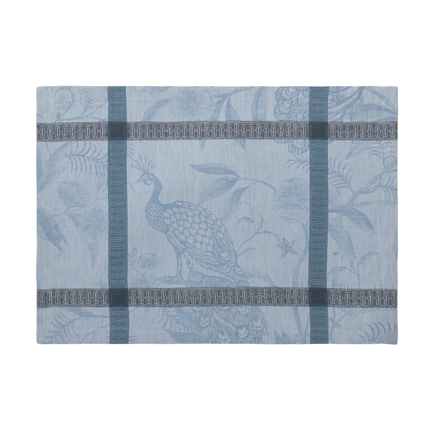 Close-up of dusty blue jacquard placemat with woven peacock and botanical motif.