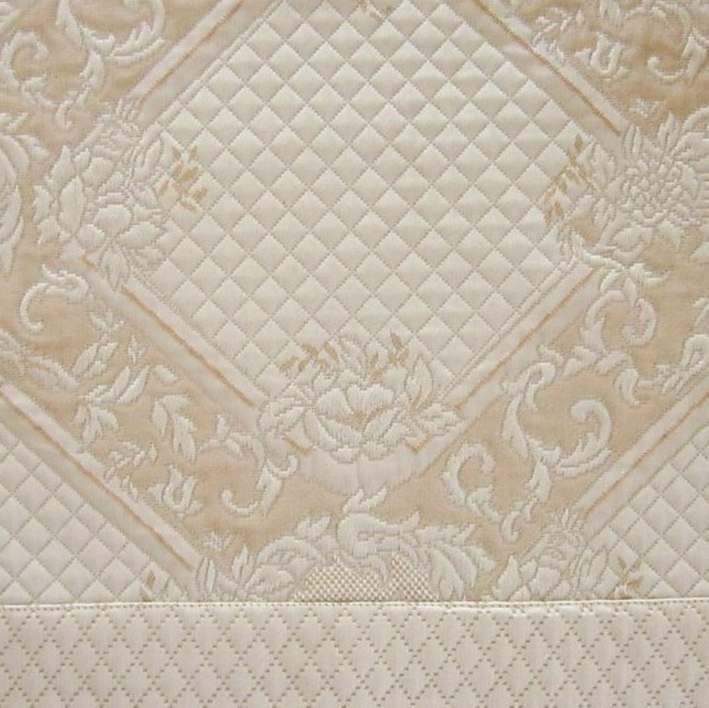 Close-up of Home Treasures Shiraz ivory jacquard weave with quilted diamond and floral motifs.