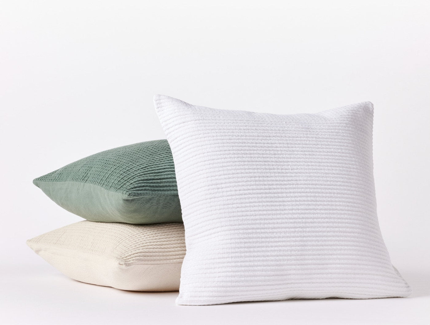 Coyuchi Marshall decorative pillow covers in white, sage, and natural, stacked trio styling.