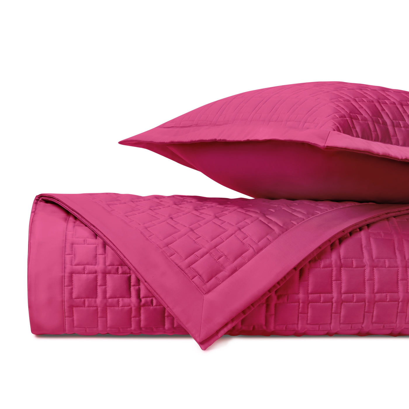 Close-up of fuchsia quilted satin with geometric square stitching pattern.