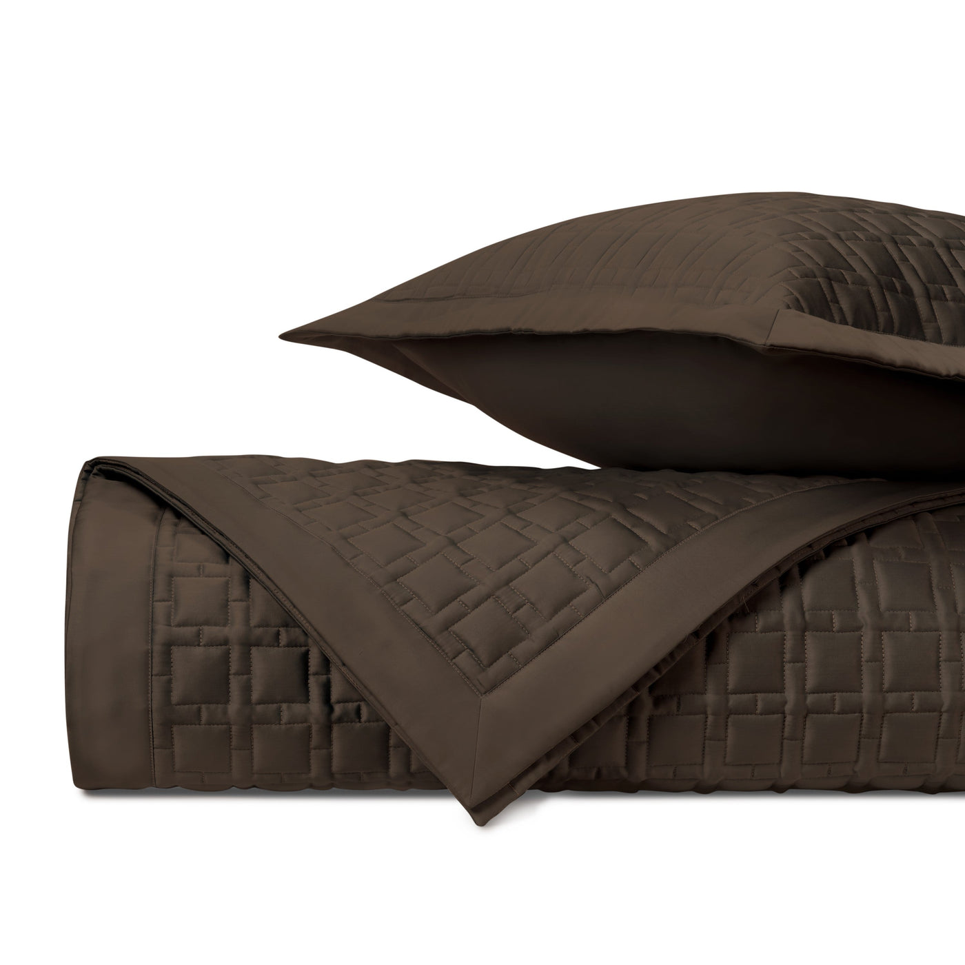 Close-up of chocolate quilted satin with geometric square stitching pattern.