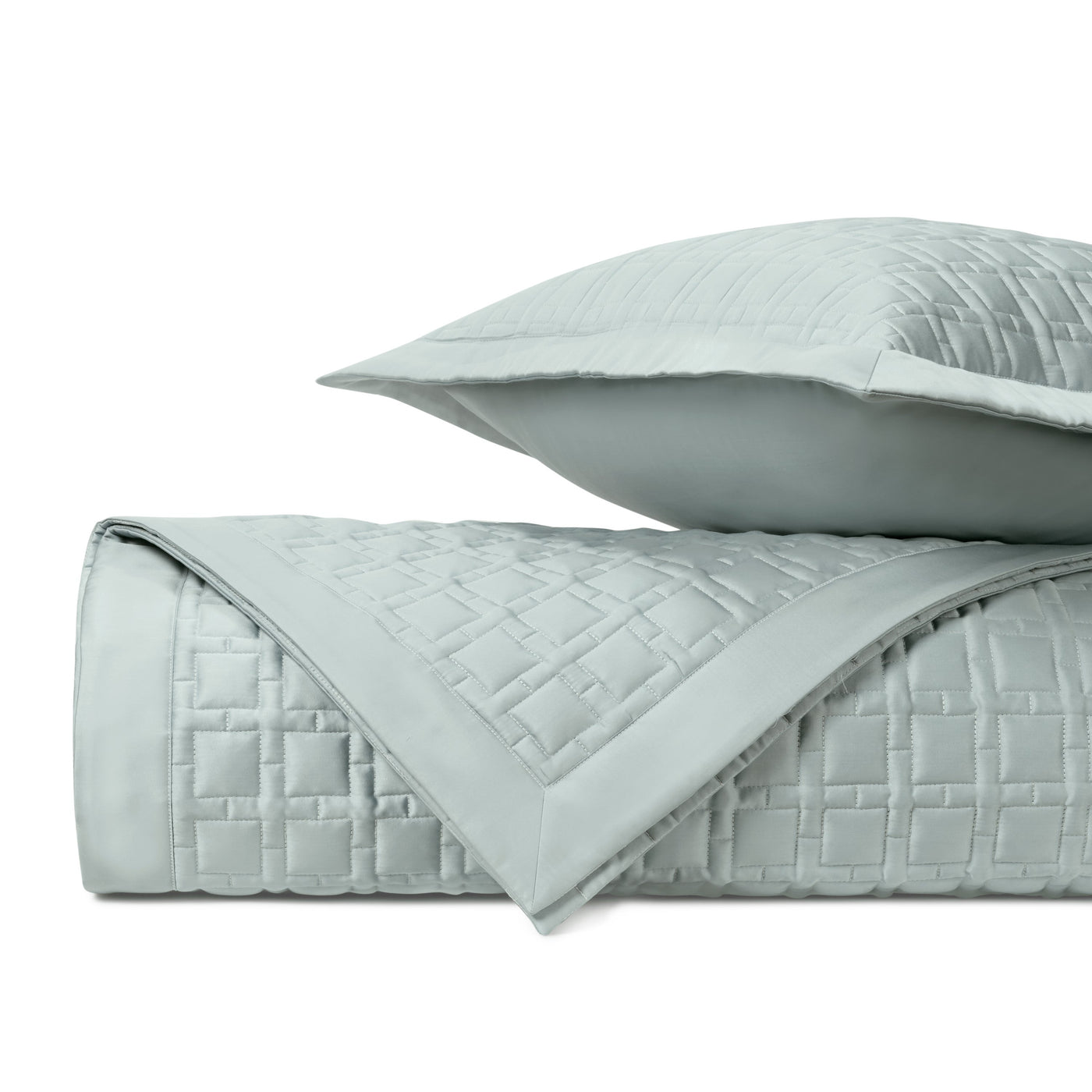 Close-up of Home Treasures Square quilted coverlet in mist blue with geometric basket-weave stitching.