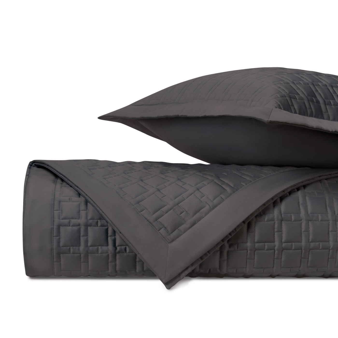 Close-up of Home Treasures Square quilted coverlet in charcoal with brick-pattern stitching.