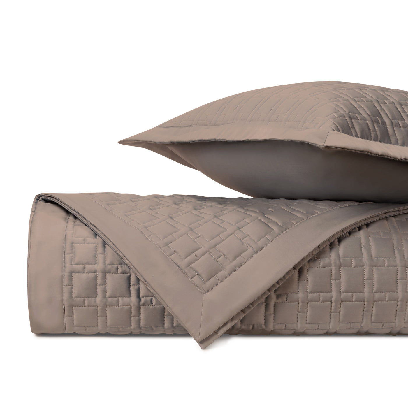 Close-up of Home Treasures Square quilted coverlet in taupe with geometric stitching.