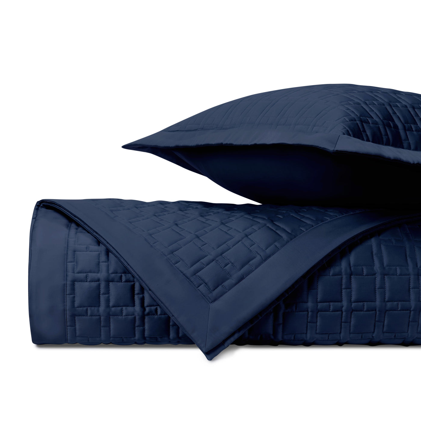 Close-up of Home Treasures Square quilted coverlet in navy with basket-weave stitching detail.