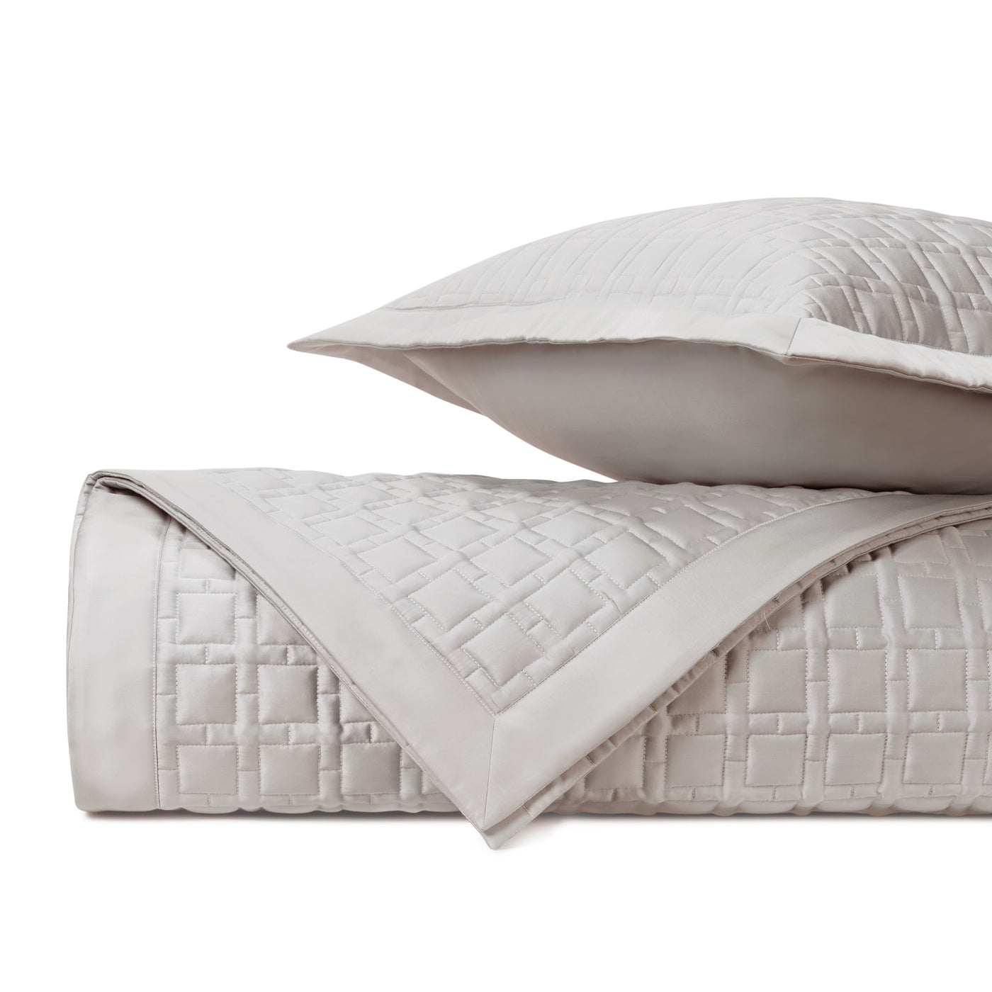Close-up of Home Treasures Square quilted texture in pearl, showing basket-weave stitching detail.