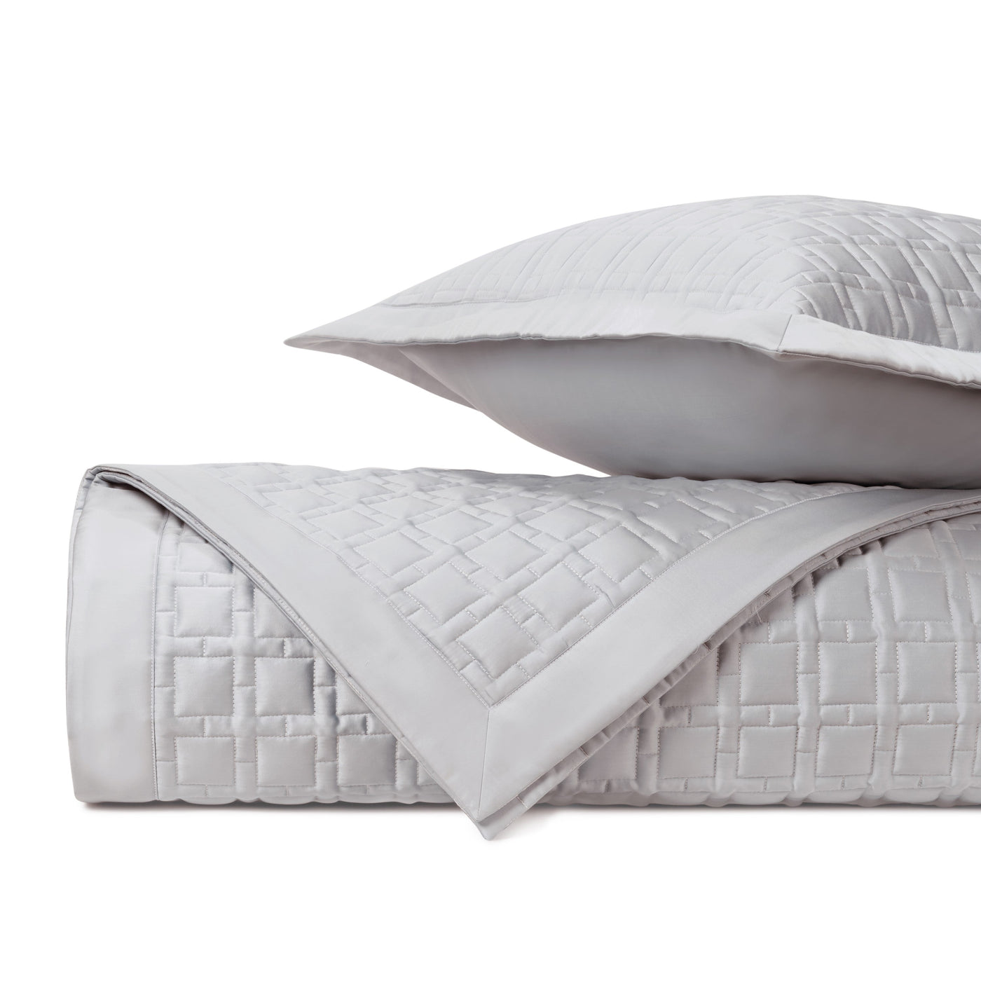 Close-up of Home Treasures Square quilted coverlet in silver-grey with geometric stitching detail.