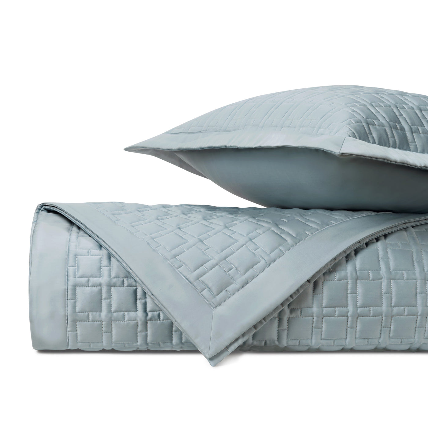 Close-up of Home Treasures Square quilted coverlet in mist blue, showing basket-weave stitching detail.