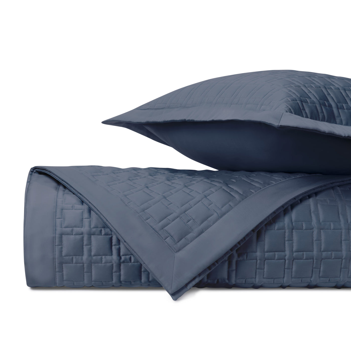 Close-up of Home Treasures Square quilted coverlet in slate blue with grid stitching.