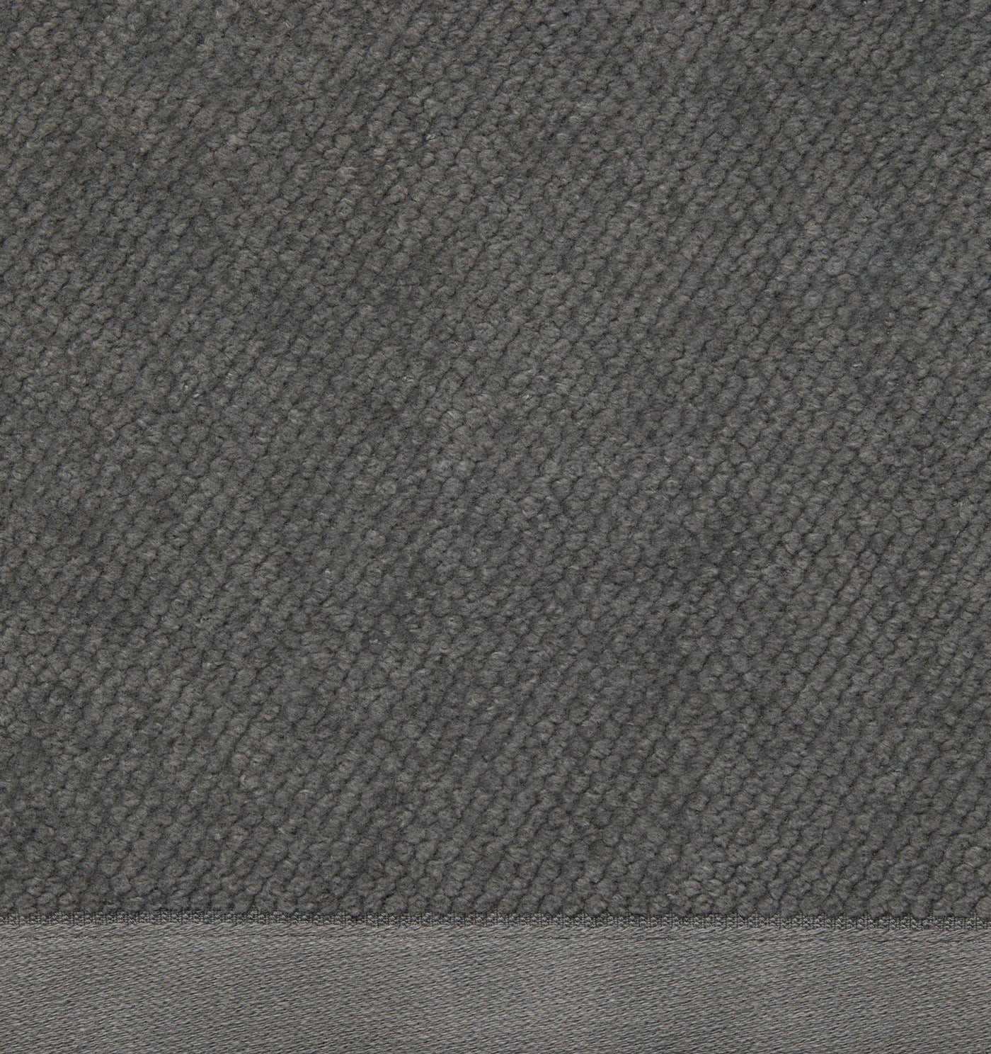 Close-up of graphite cotton terry tub mat showing textured loop pile and woven border hem.