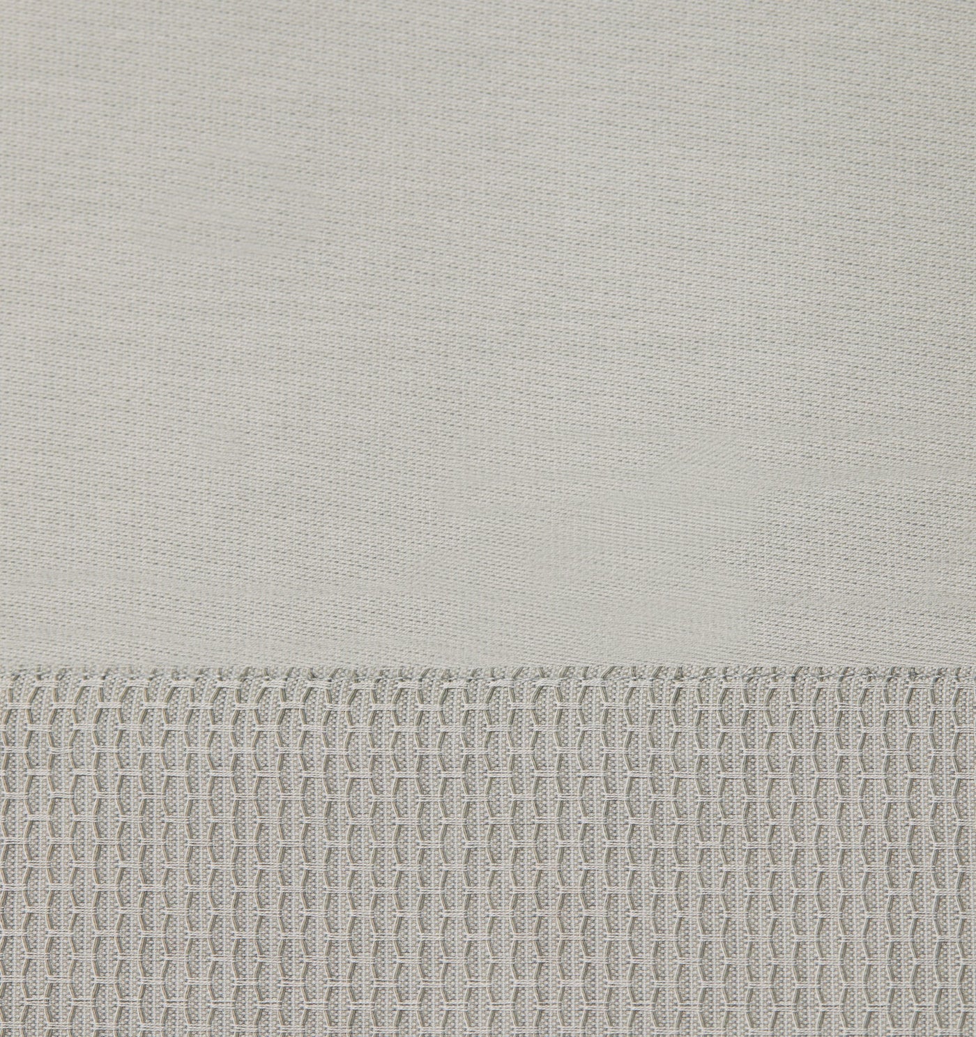 Close-up of Sferra Carlotta ivory fitted sheet showing contrast waffle-weave hem border.
