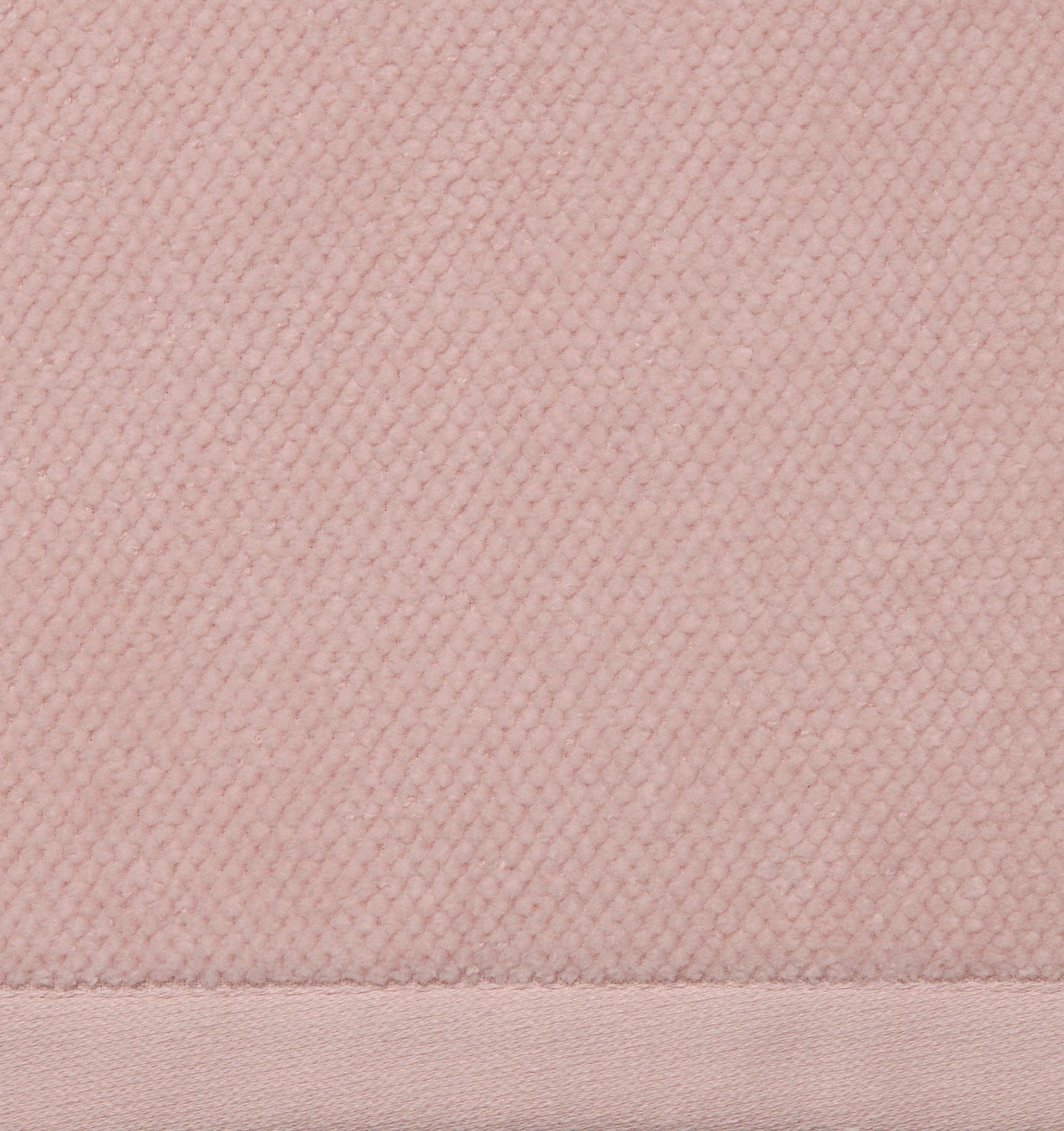 Close-up of Sferra Canedo Nuovo tub mat showing blush textured weave and woven border hem.