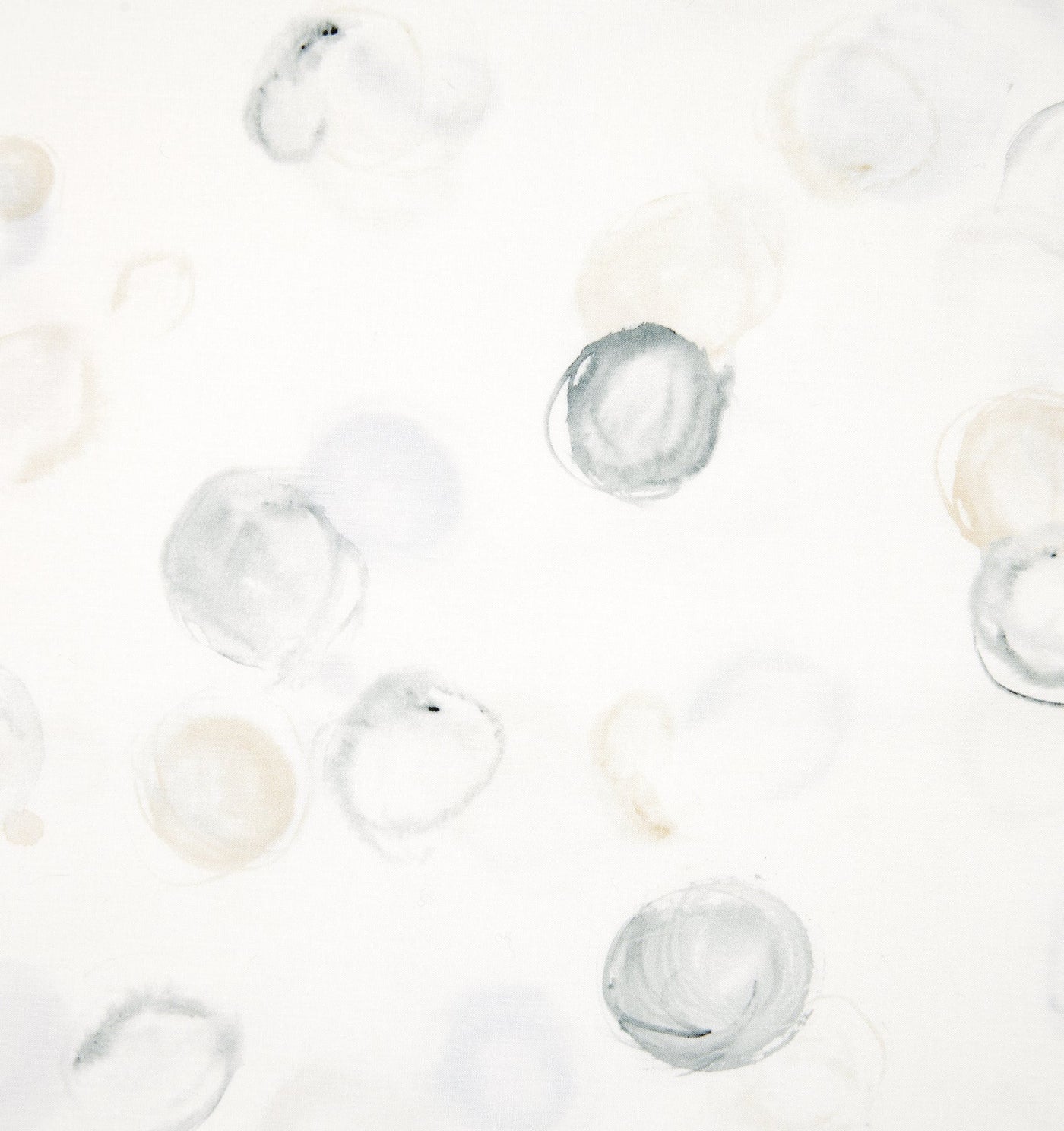 Close-up of Sferra Punti fitted sheet fabric showing watercolor circle print in silver and champagne.
