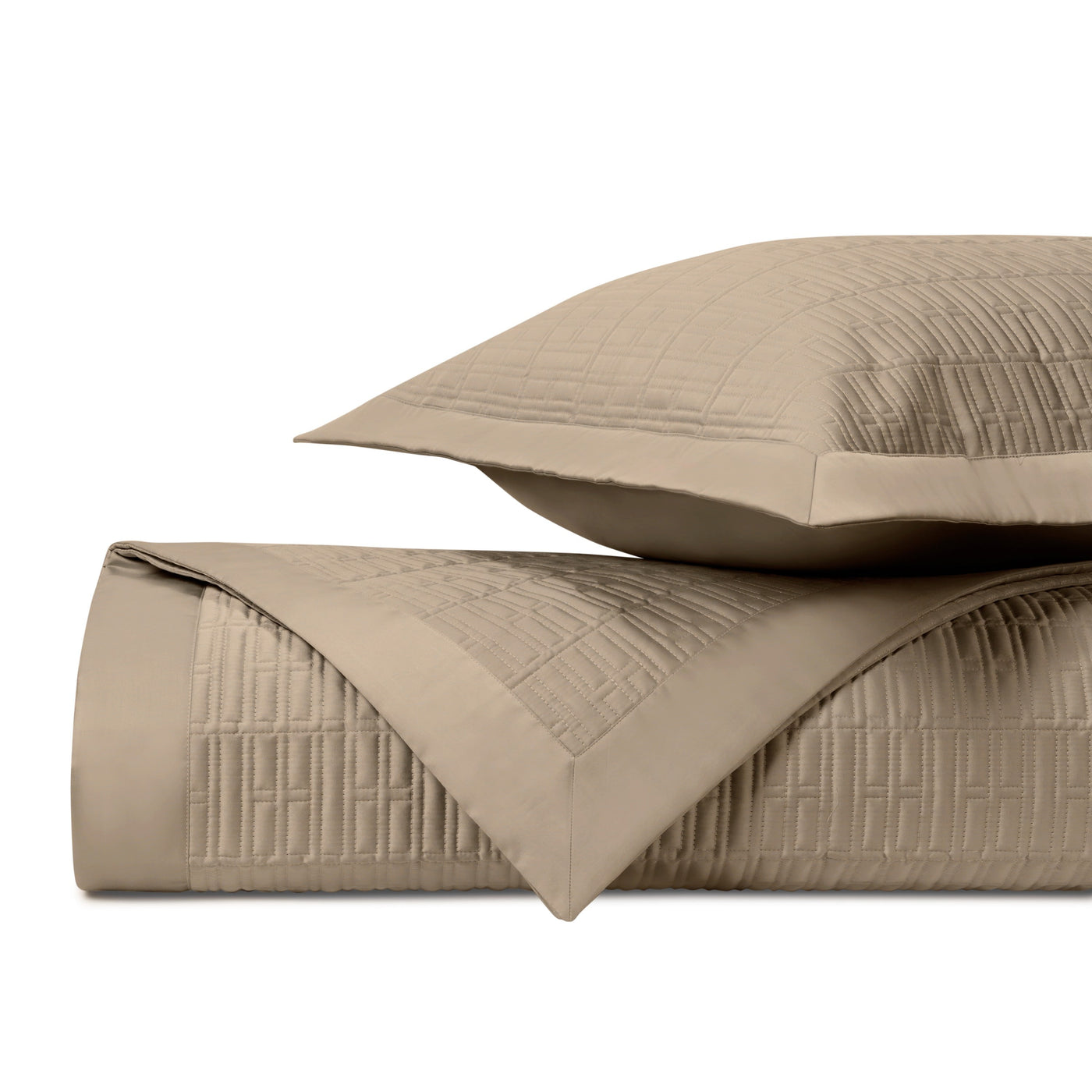 Close-up of Sydney quilted texture in taupe, showing geometric stitched pattern on folded coverlet and sham.