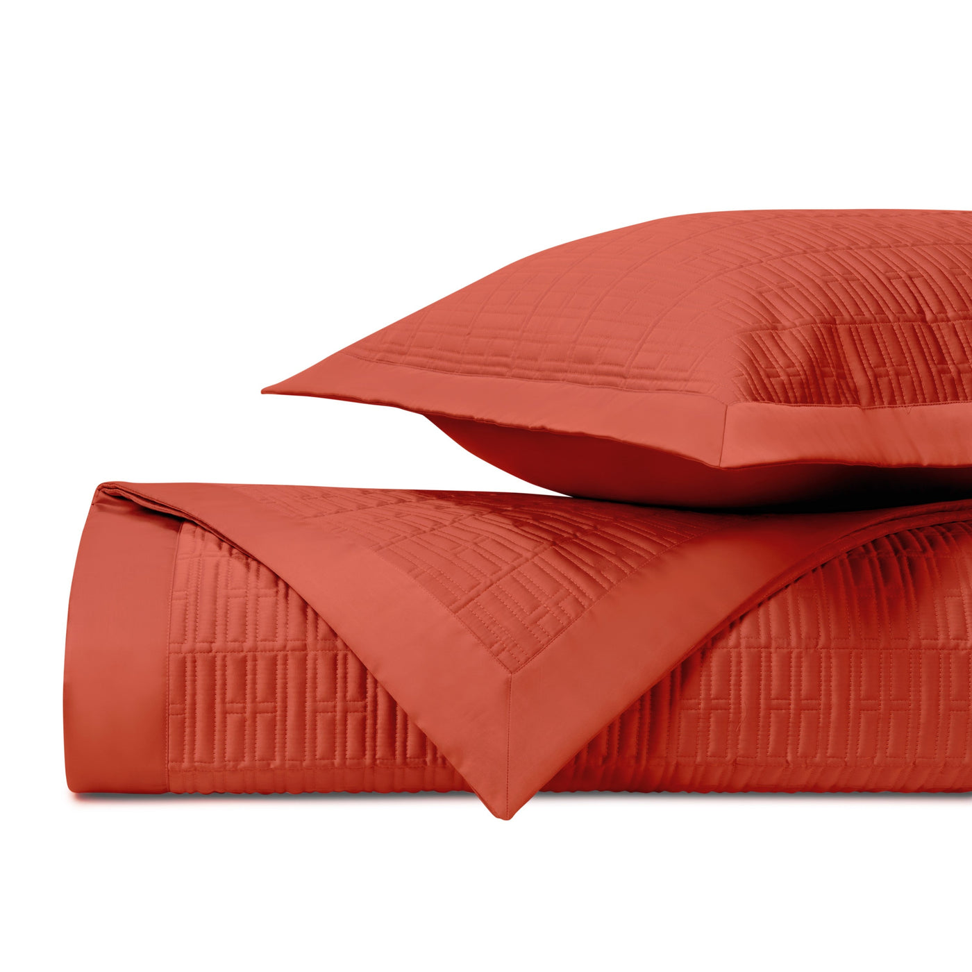 Close-up of Sydney quilted coverlet and sham in terracotta with geometric stitching.