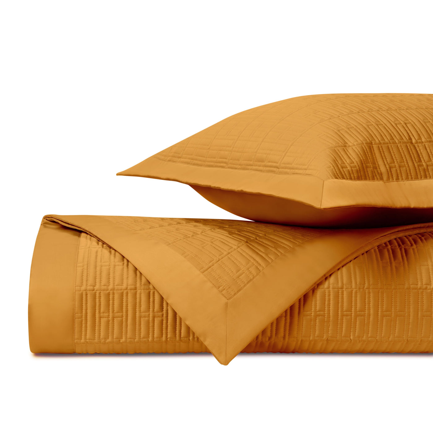 Close-up of Home Treasures Sydney quilted texture in marigold, stacked coverlet and sham.