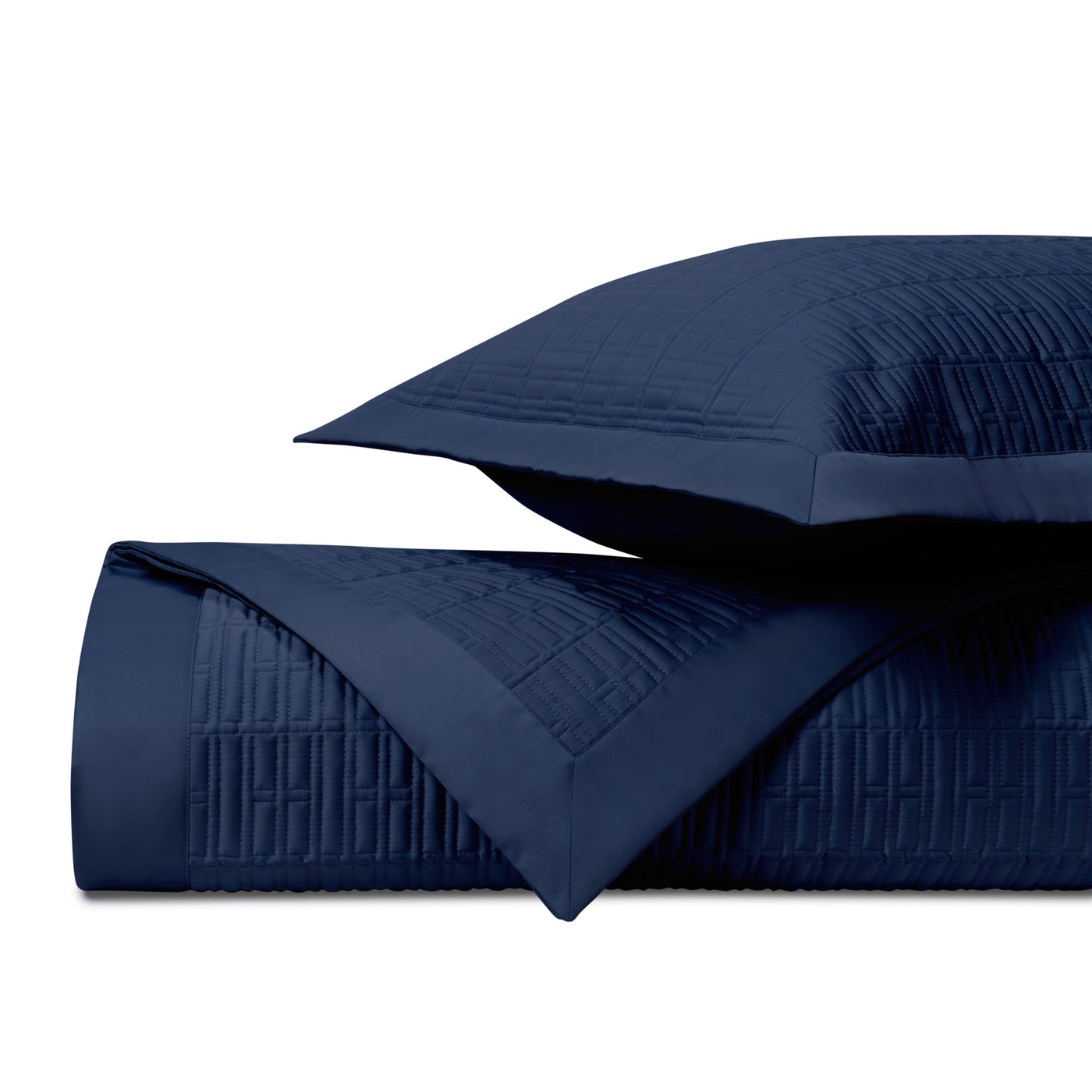 Close-up of navy blue quilted satin with geometric channel stitching detail.