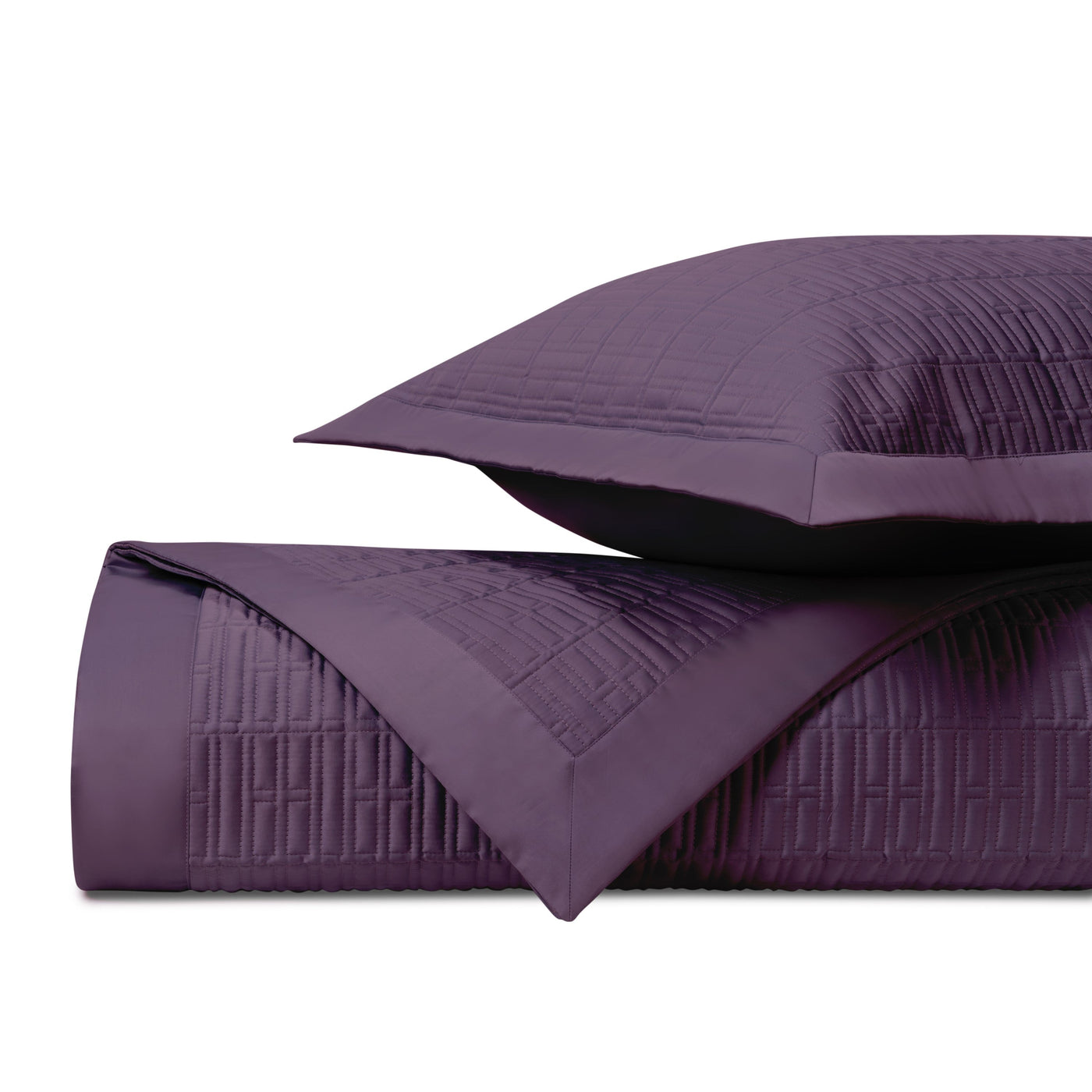 Amethyst quilted coverlet and sham stack showing geometric stitched pattern detail.