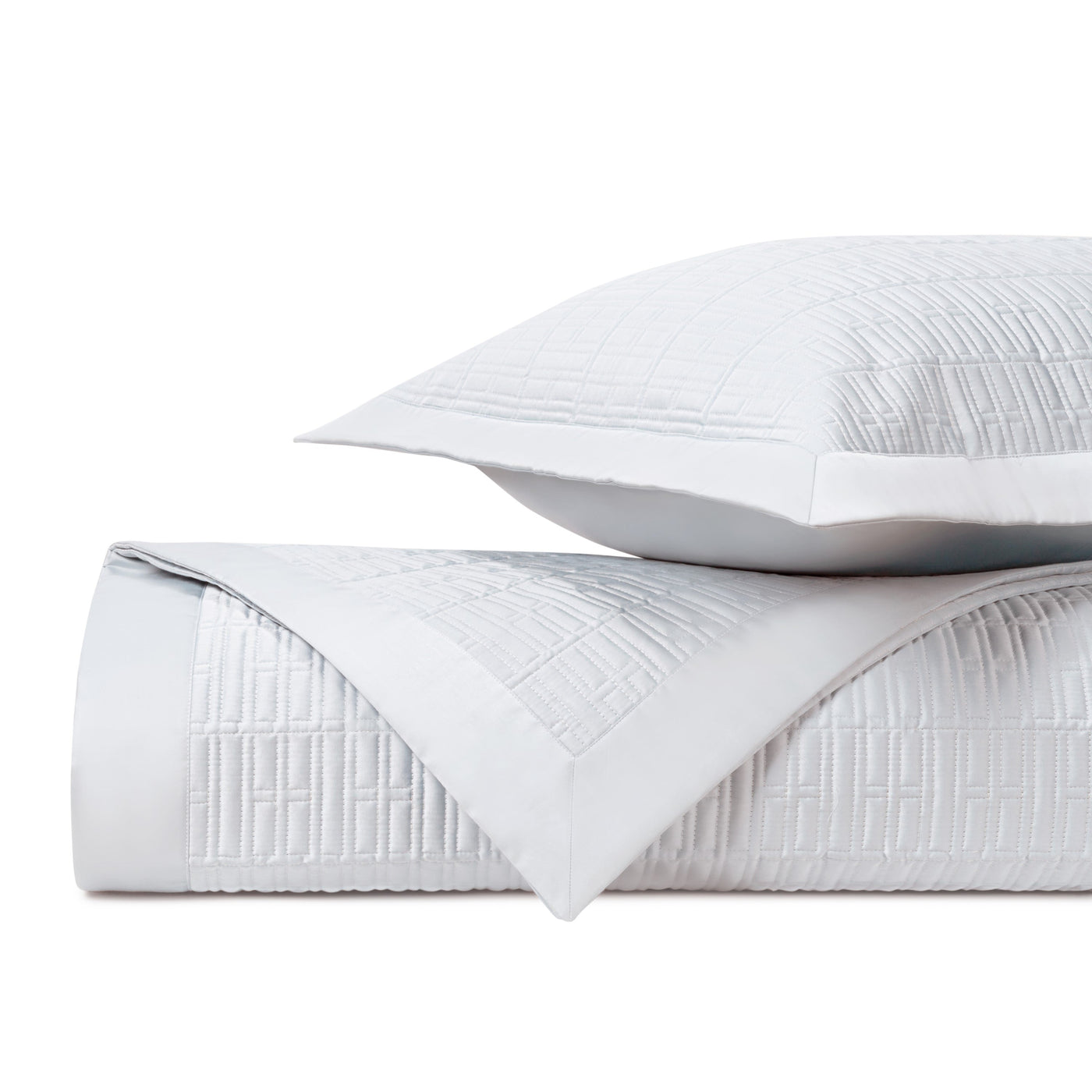 Pearl white quilted coverlet and sham with geometric grid stitching detail.