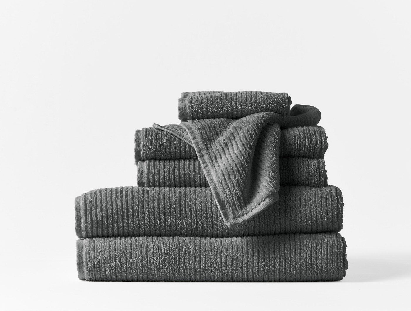 Coyuchi Temescal Ribbed towels stacked in charcoal, showing ribbed texture detail.