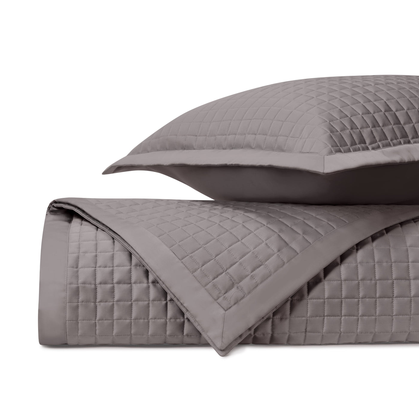 Close-up of Home Treasures Time Square quilted coverlet in taupe with grid stitching detail.