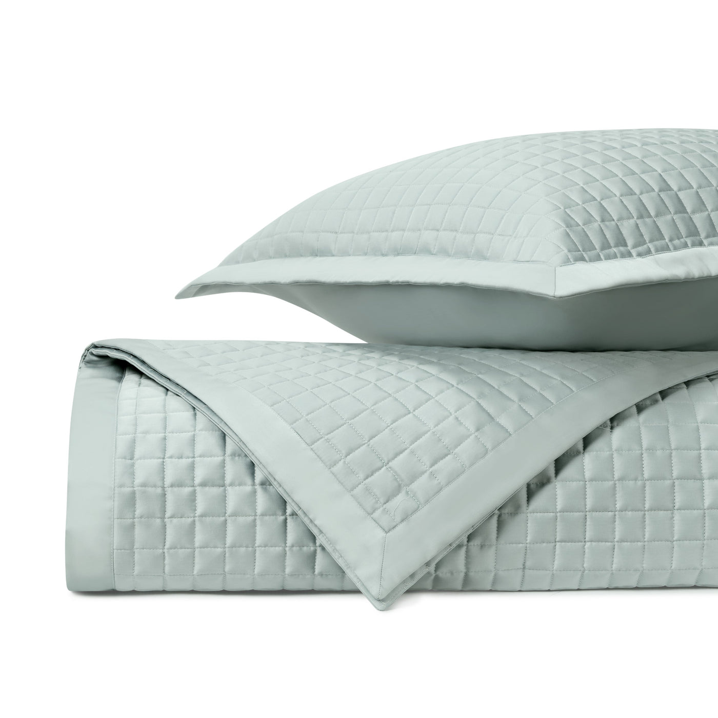 Close-up of Time Square quilted coverlet set in mist blue, showing geometric square stitching pattern.