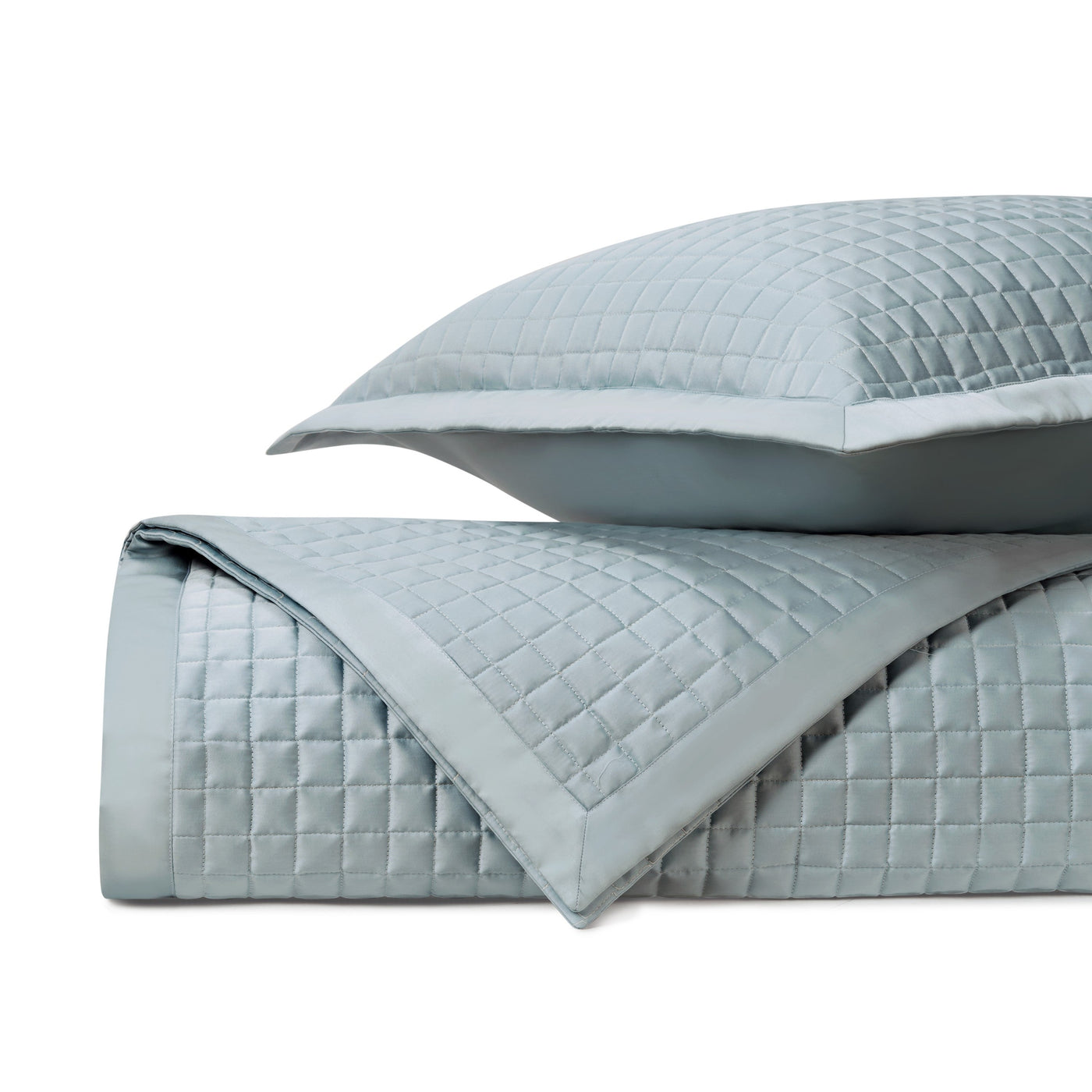 Close-up of Home Treasures Time Square quilted coverlet in mist blue, showing grid stitch detail.
