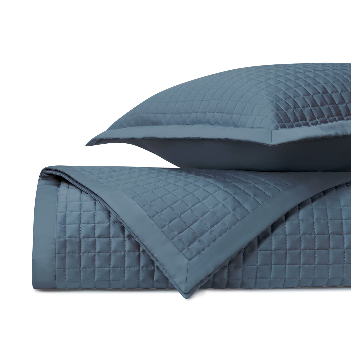 Home Treasures Time Square quilted coverlet and sham in slate blue with grid stitching.