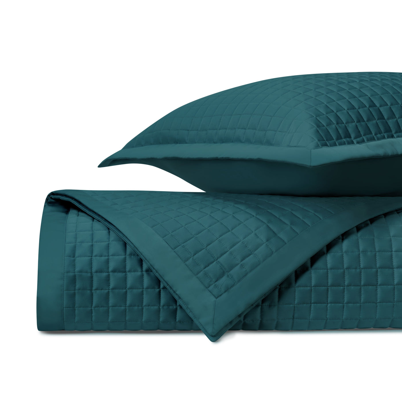 Teal quilted coverlet folded to show diamond-stitched texture, with matching sham.
