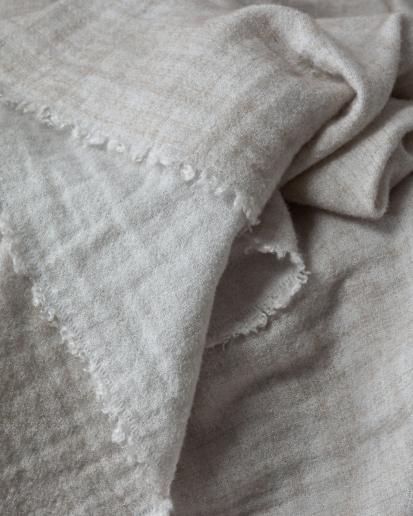 Close-up of Society Limonta Tiub throw showing frayed edge detail in natural linen.