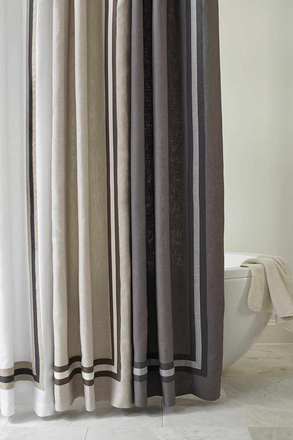 Close-up of Home Treasures Torino linen shower curtain in layered ivory, taupe, and charcoal stripes.