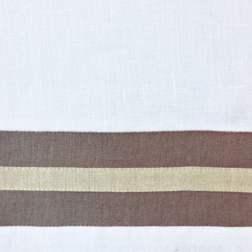 Close-up of white linen weave with mocha and champagne woven border stripe detail.