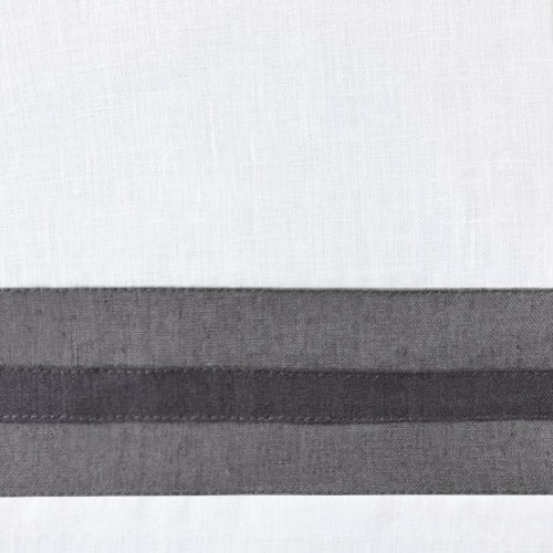 Close-up of white linen with charcoal woven border stripe detail.