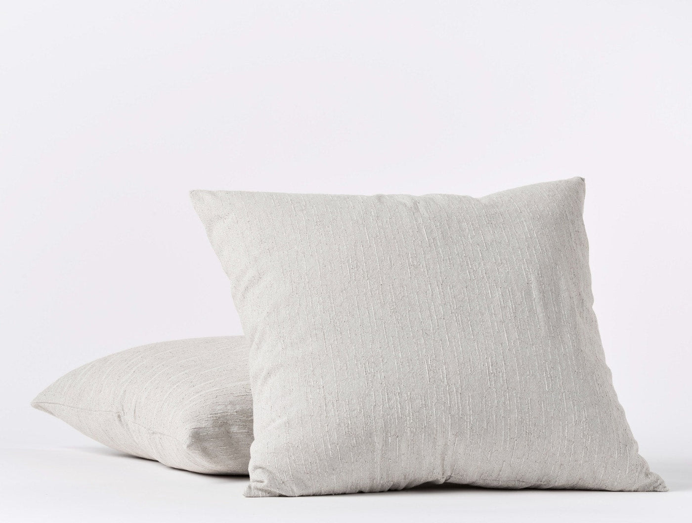 Pair of Coyuchi Toro Canyon shams in silver grey, showing front and side stacking view.