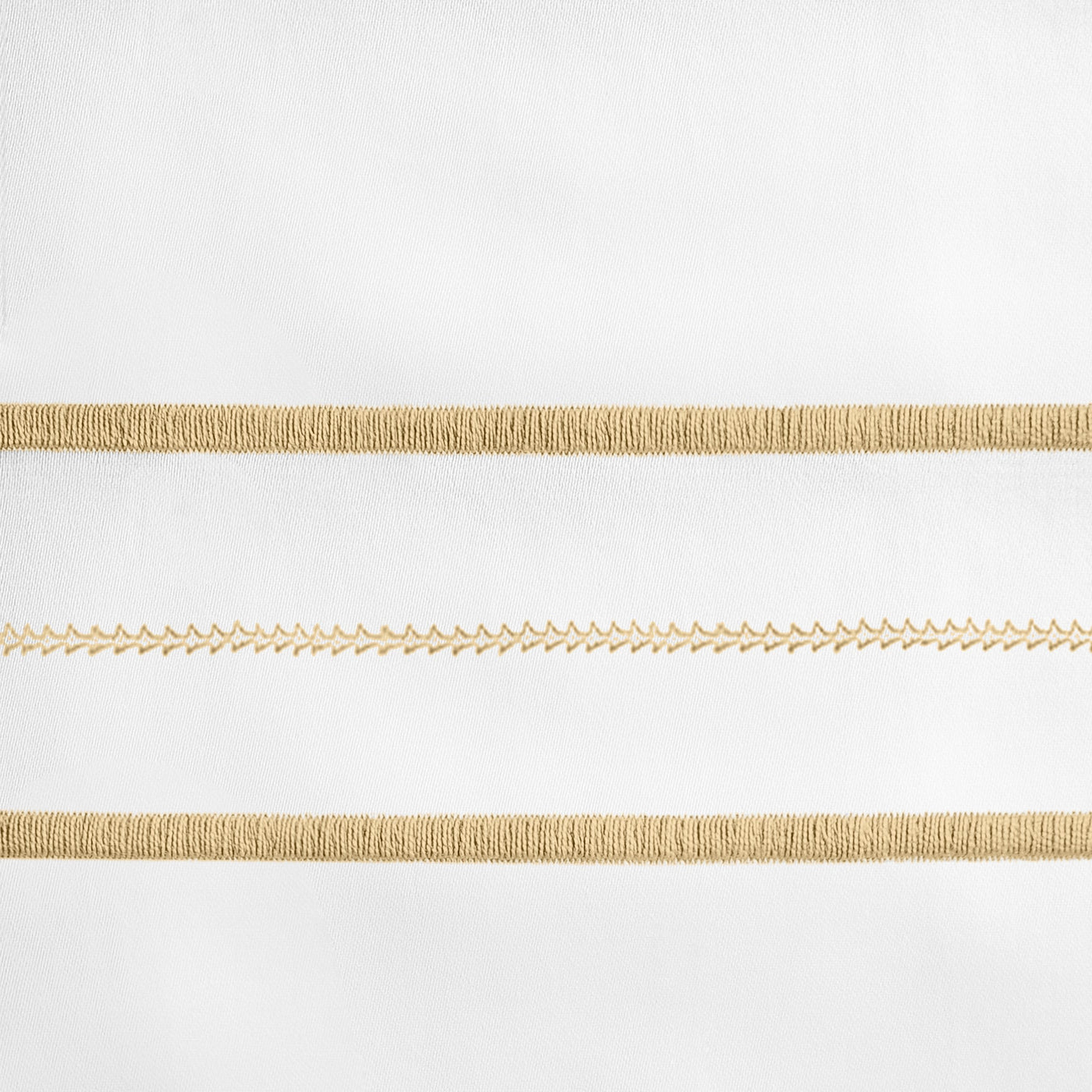 Close-up of champagne embroidered stripe detail on white linen fabric.