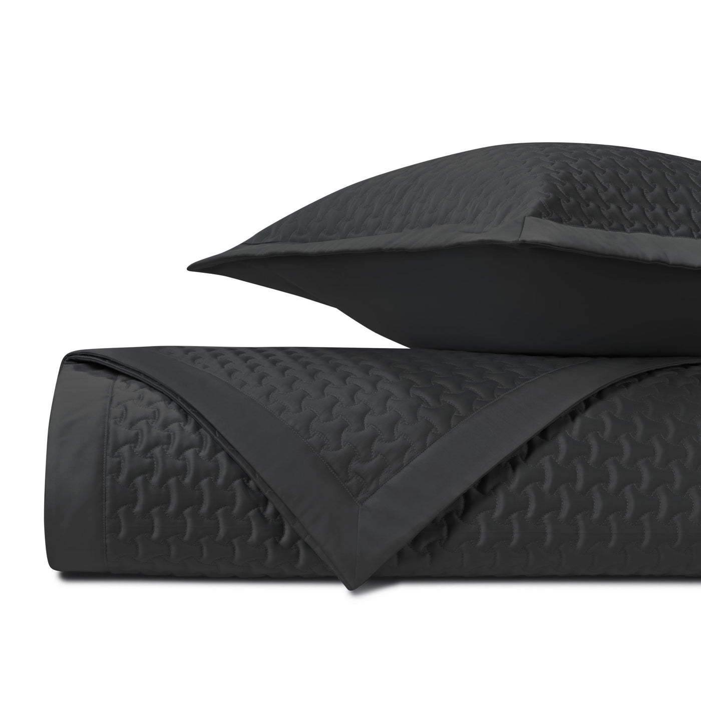 Close-up of Home Treasures Trinity quilted coverlet in black with geometric stitching.