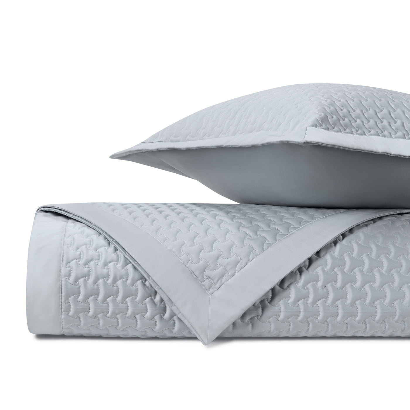 Close-up of Home Treasures Trinity quilted coverlet in silver-blue with geometric stitching.