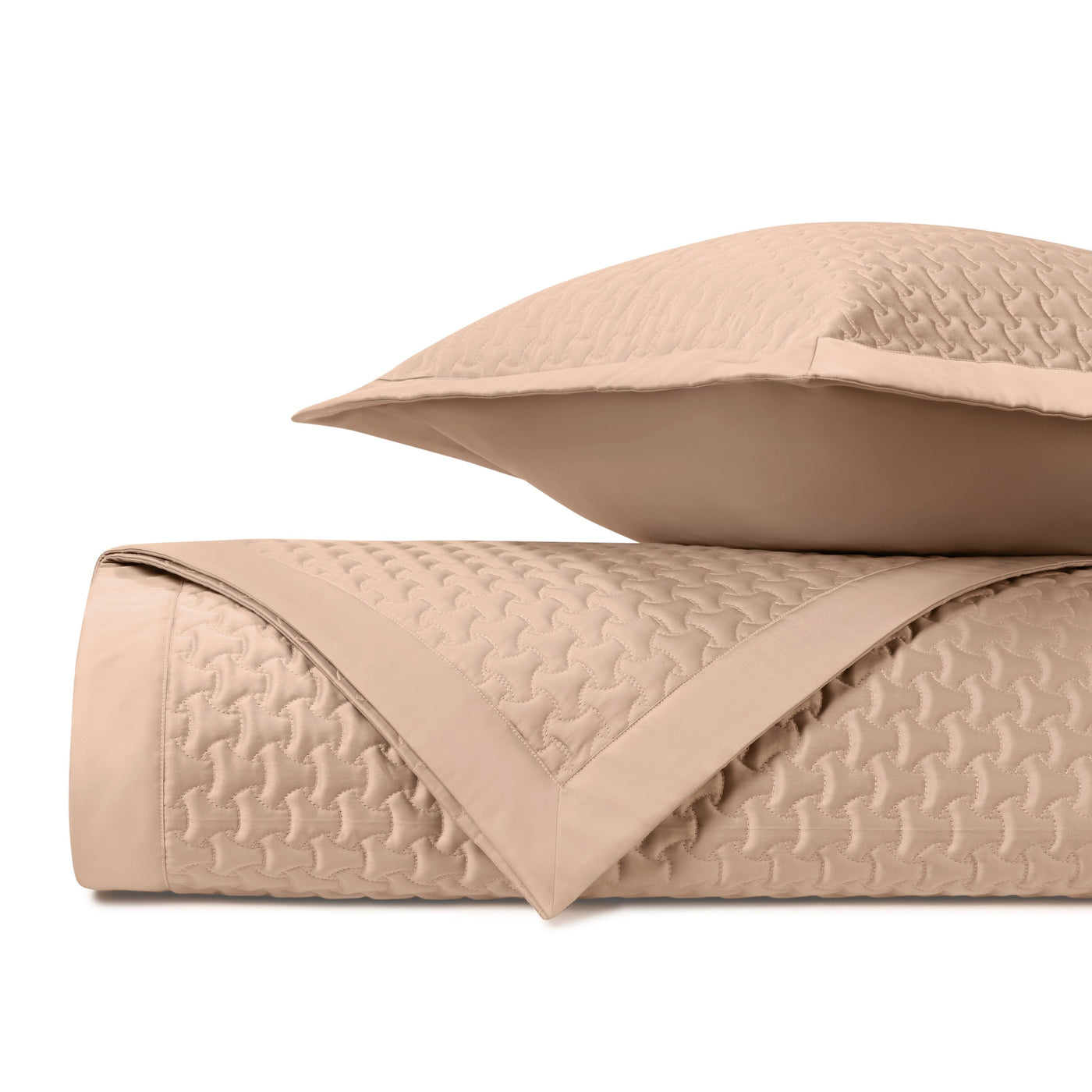 Close-up of Home Treasures Trinity quilted texture in warm sand with geometric pattern.