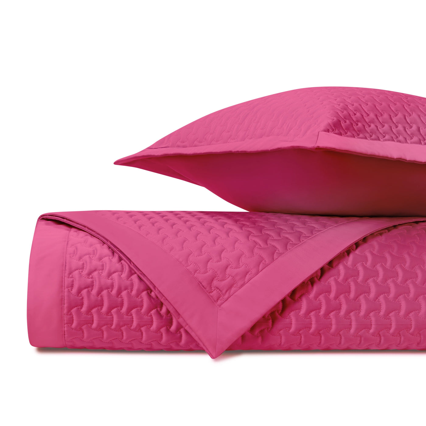 Close-up of Home Treasures Trinity quilted coverlet in fuchsia with houndstooth texture.