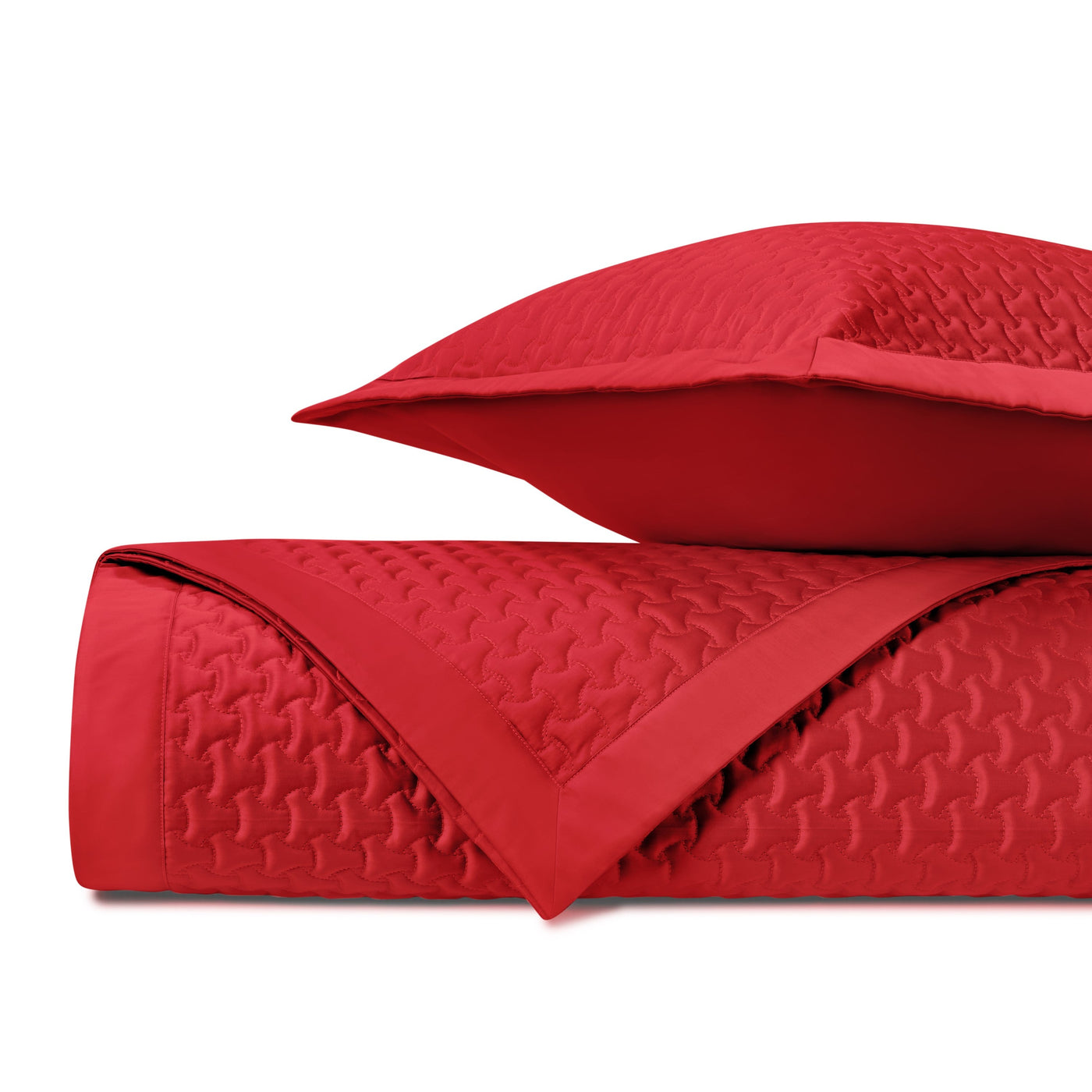 Close-up of crimson quilted texture with geometric houndstooth-style stitching pattern.