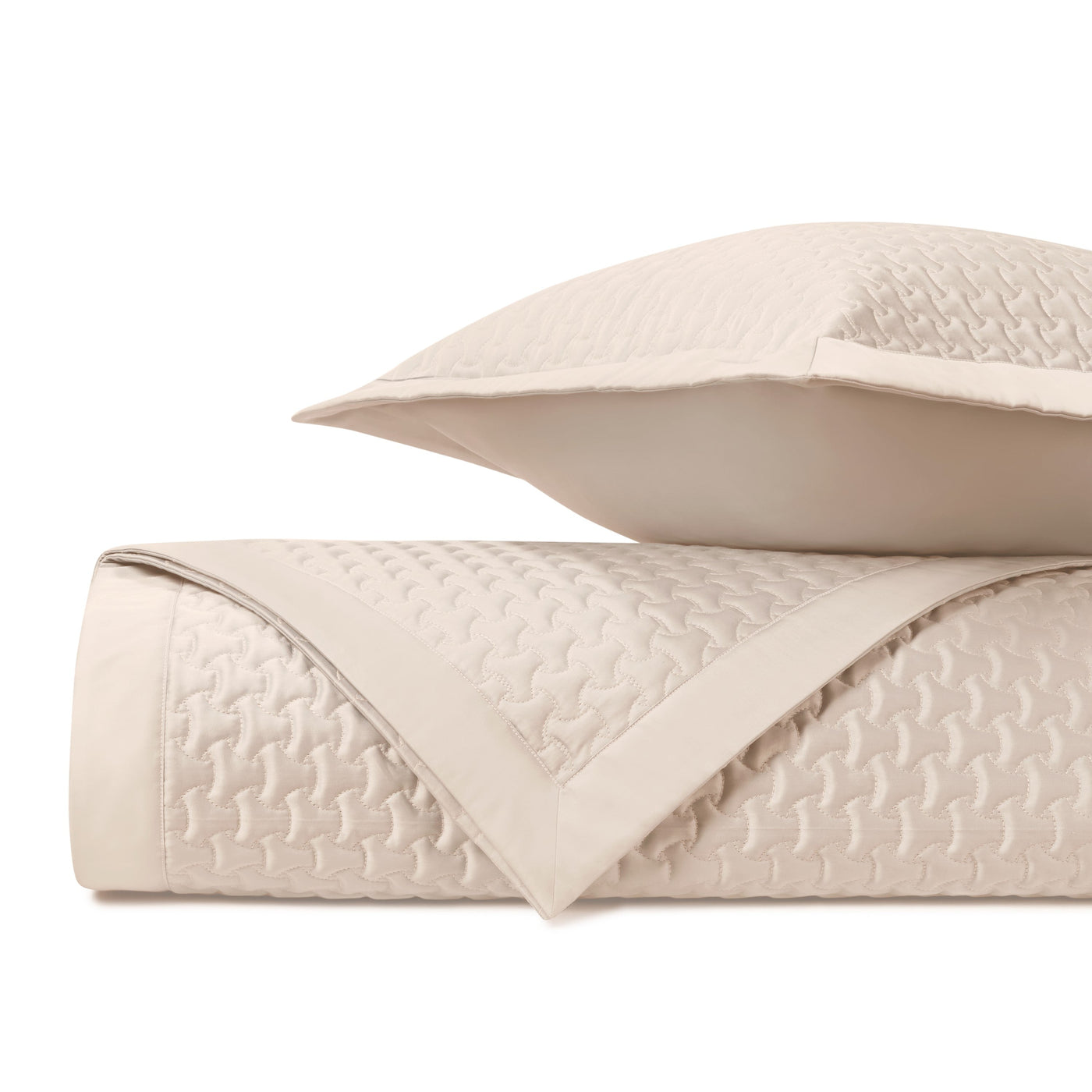 Close-up of Home Treasures Trinity quilted texture in ivory with geometric pattern.