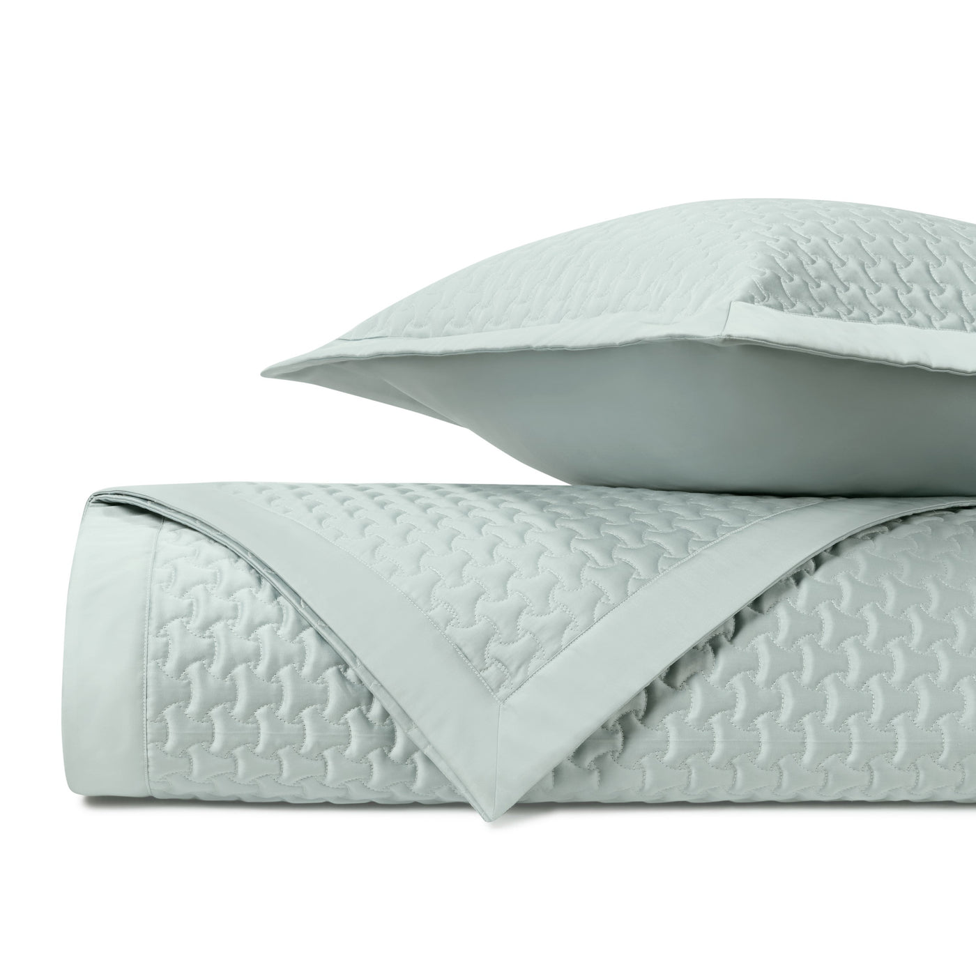 Close-up of Home Treasures Trinity quilted coverlet in mist, showing geometric stitch pattern.