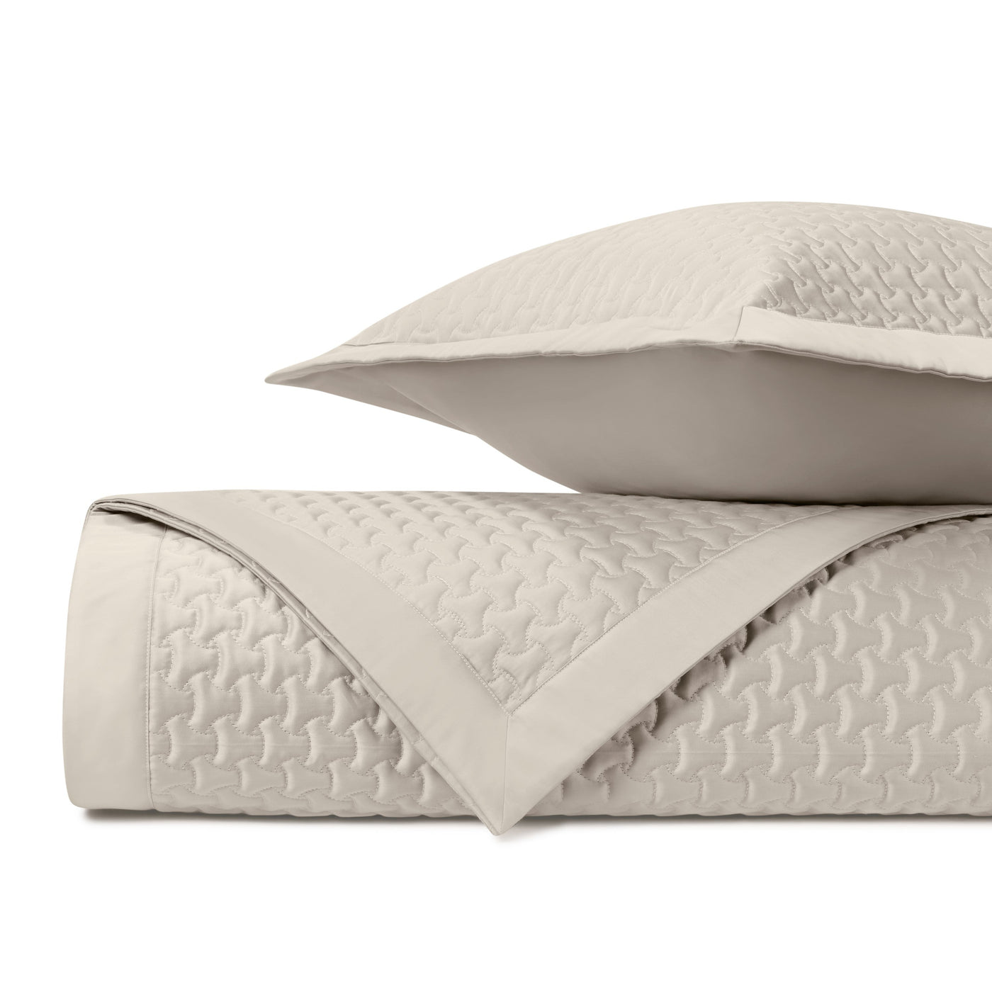 Close-up of Home Treasures Trinity quilted texture in ivory with geometric stitching detail.