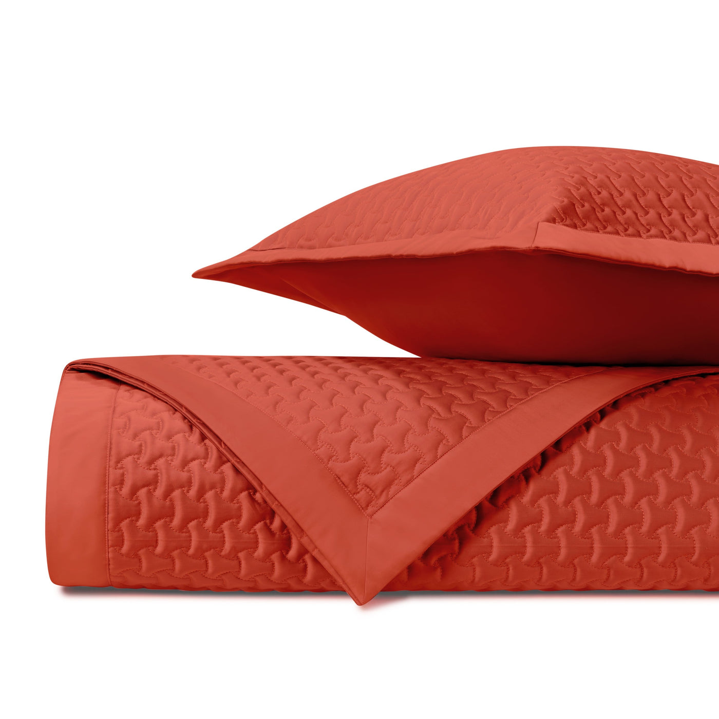 Close-up of Home Treasures Trinity quilted texture in tomato red with geometric stitching.